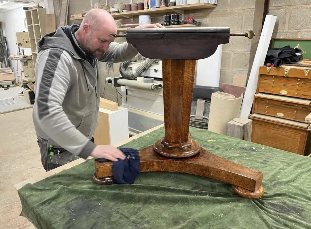Neil O’Brien working on an antique table at The Well Barn